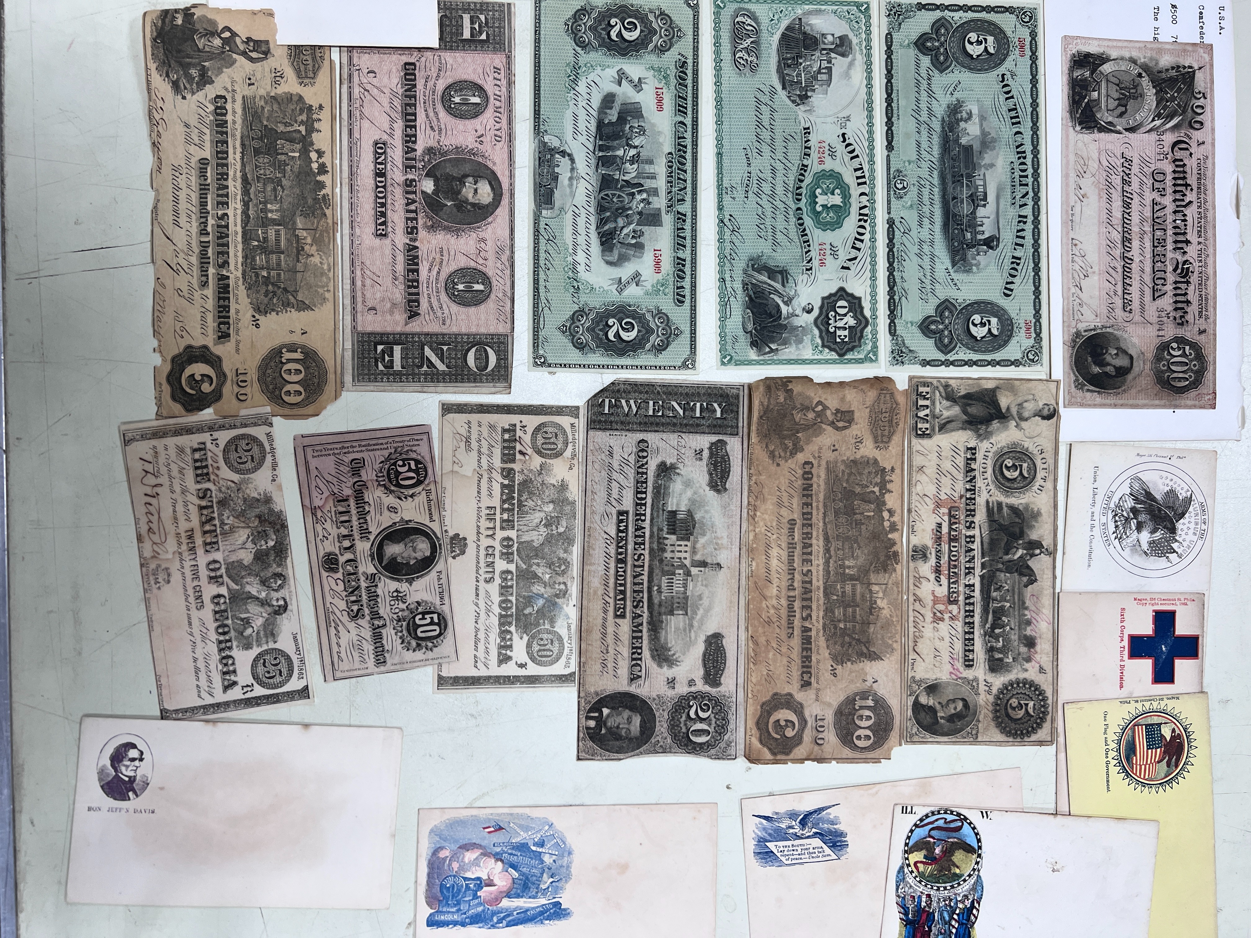 A collection of US Confederate States banknotes, including a confederate states of America $500 seventh issue 17 February 1864, $100 Richmond July 4 1862 x 2 and another 1864, and many others
